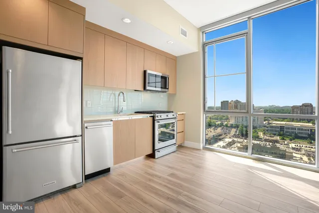 a kitchen with a refrigerator and a stove top oven