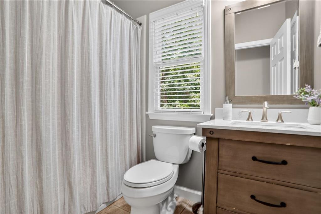 4760 Fontwell Court Suwanee, GA 30024 - Photo 12 of 43 a bathroom with a sink a toilet and shower