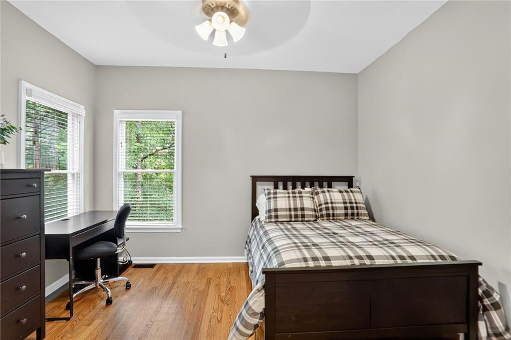 4760 Fontwell Court Suwanee, GA 30024 - Photo 13 of 43 a bedroom with a bed and a desk