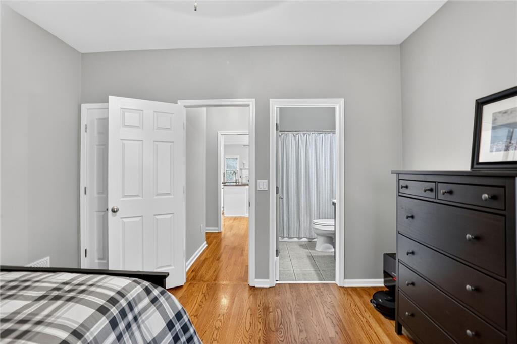 4760 Fontwell Court Suwanee, GA 30024 - Photo 14 of 43 a bedroom with a bed and a dresser