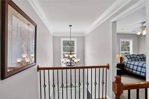 a view of a room with wooden floor and windows