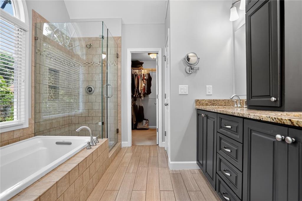 4760 Fontwell Court Suwanee, GA 30024 - Photo 18 of 43 a bathroom with a granite countertop tub sink shower and mirror