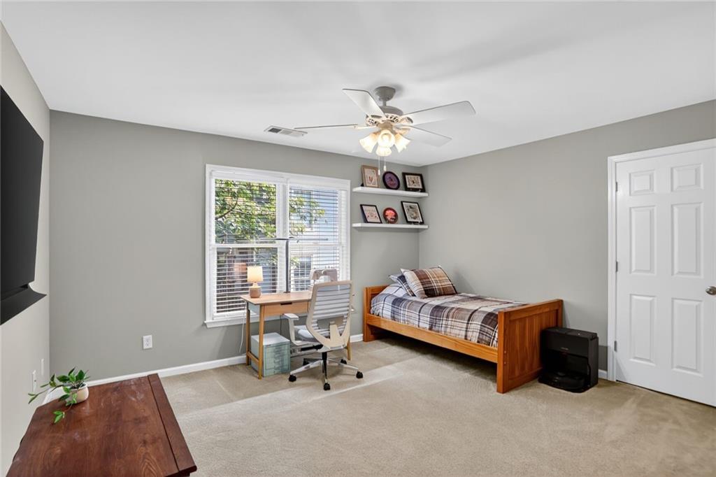4760 Fontwell Court Suwanee, GA 30024 - Photo 24 of 43 a bedroom with furniture and a window