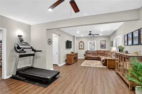 a living room with furniture and a wooden floor