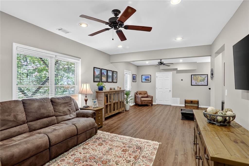 4760 Fontwell Court Suwanee, GA 30024 - Photo 28 of 43 a living room with furniture and a large window