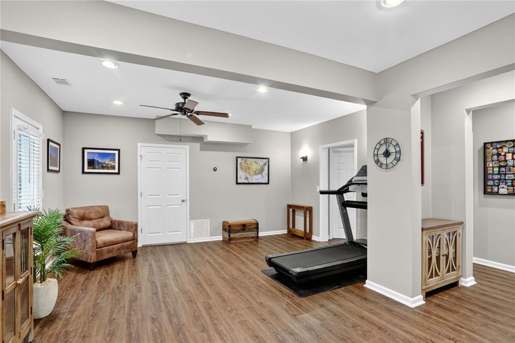 4760 Fontwell Court Suwanee, GA 30024 - Photo 29 of 43 a living room with furniture and a wooden floor