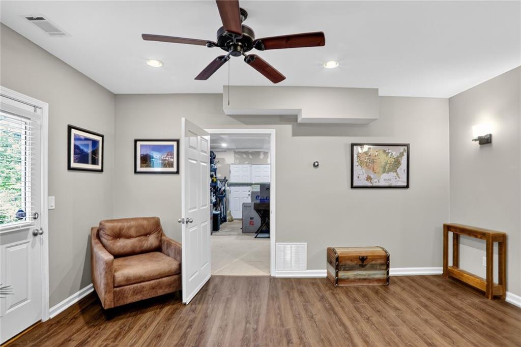 4760 Fontwell Court Suwanee, GA 30024 - Photo 30 of 43 a living room with furniture and a ceiling fan