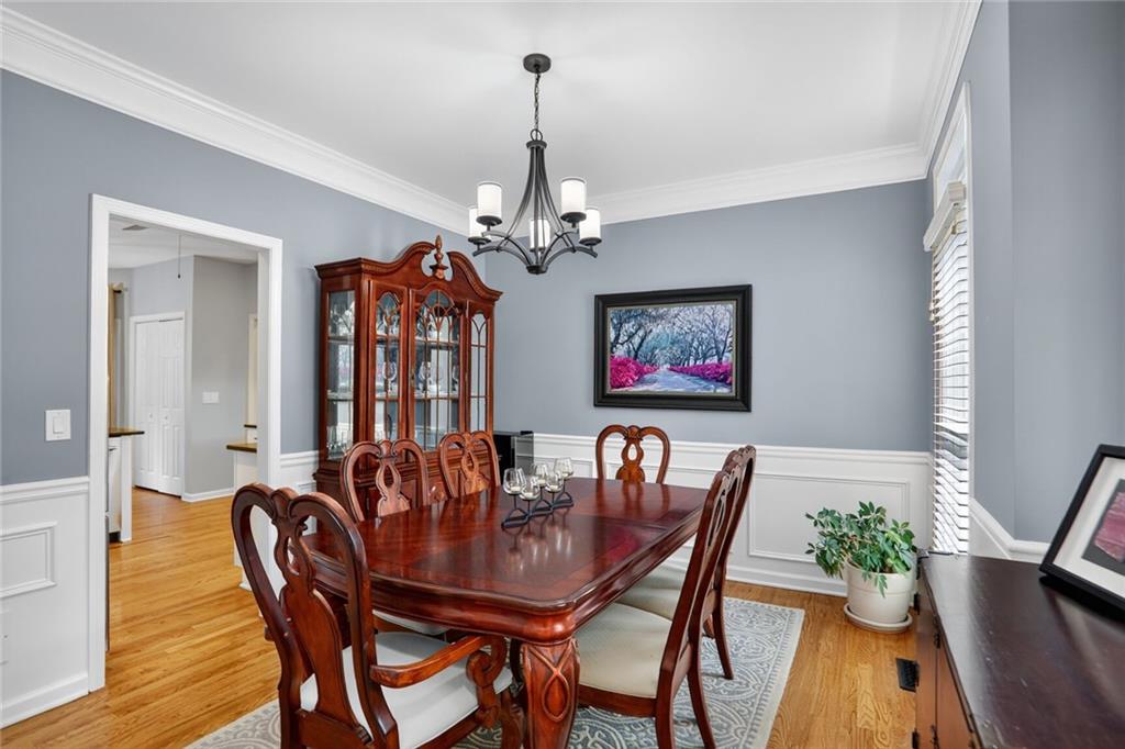 4760 Fontwell Court Suwanee, GA 30024 - Photo 3 of 43 a view of a dining room with furniture wooden floor and chandelier
