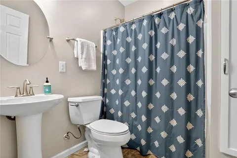 a bathroom with a sink a toilet and a mirror
