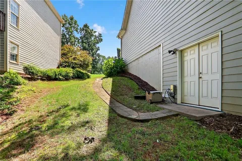 a view of a backyard with sitting area and garden