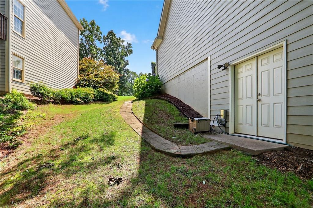 4760 Fontwell Court Suwanee, GA 30024 - Photo 34 of 43 a view of a backyard with sitting area and garden