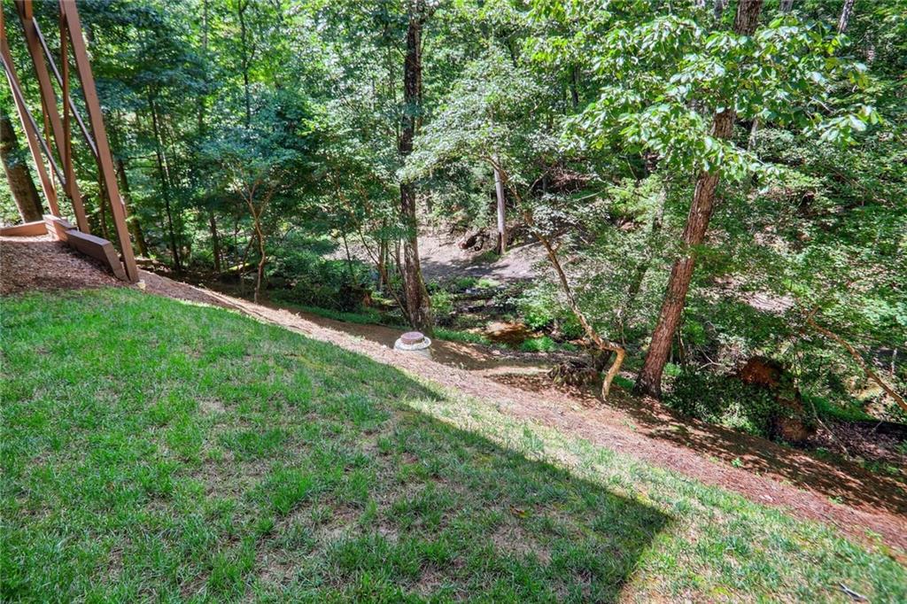 4760 Fontwell Court Suwanee, GA 30024 - Photo 35 of 43 a view of a yard with plants and a large tree