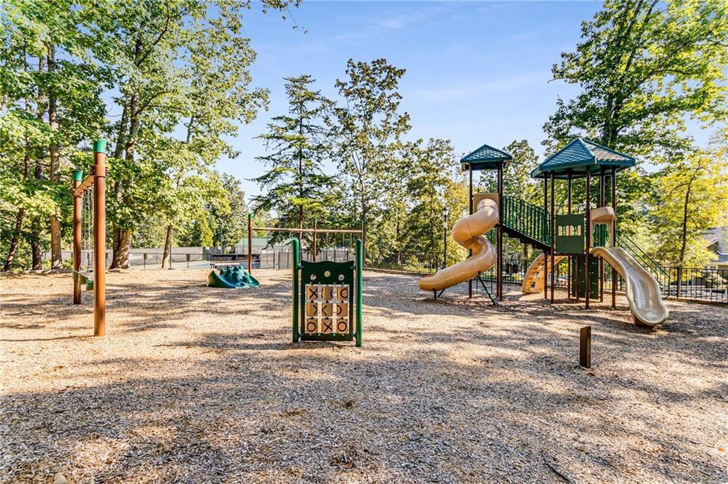 4760 Fontwell Court Suwanee, GA 30024 - Photo 41 of 43 a view of a park with swings and slides
