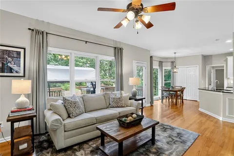 a living room with furniture large window and a table