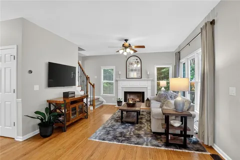 a living room with furniture a flat screen tv and a fireplace