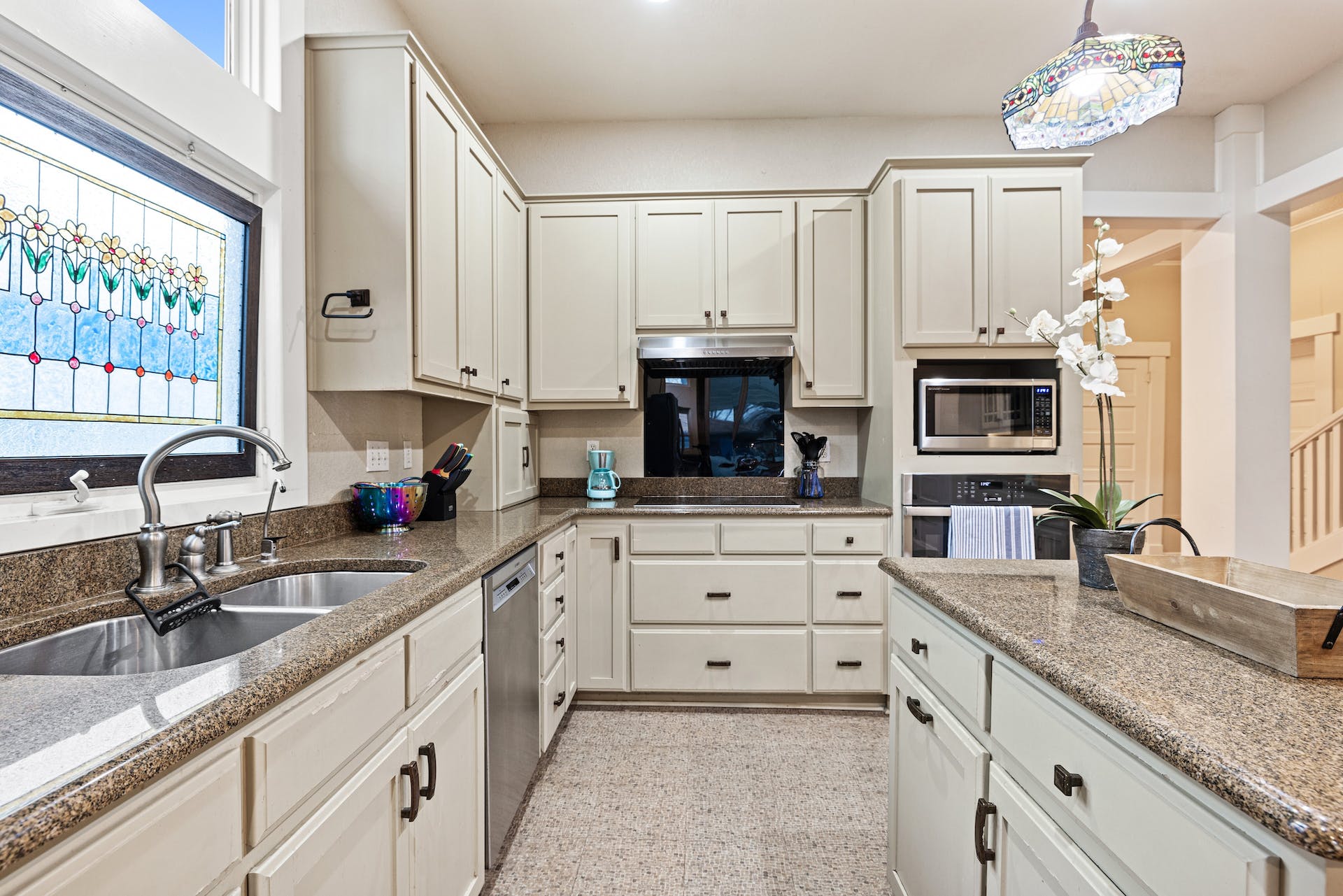 1211 Lexington Street Taylor, TX 76574 - Photo 12 of 40 a kitchen with granite countertop a sink stainless steel appliances and cabinets