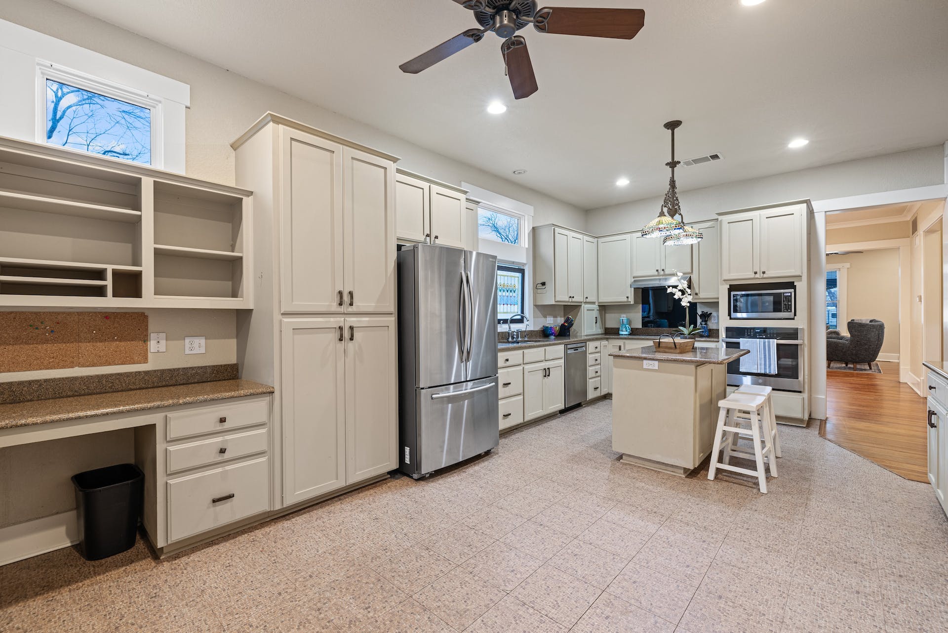 1211 Lexington Street Taylor, TX 76574 - Photo 13 of 40 a kitchen with white cabinets and stainless steel appliances