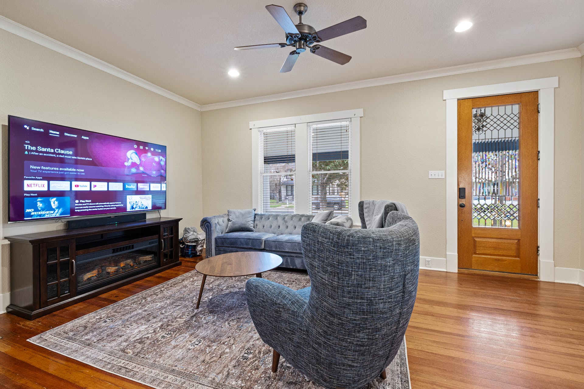 1211 Lexington Street Taylor, TX 76574 - Photo 2 of 40 a living room with furniture a flat screen tv and wooden floor