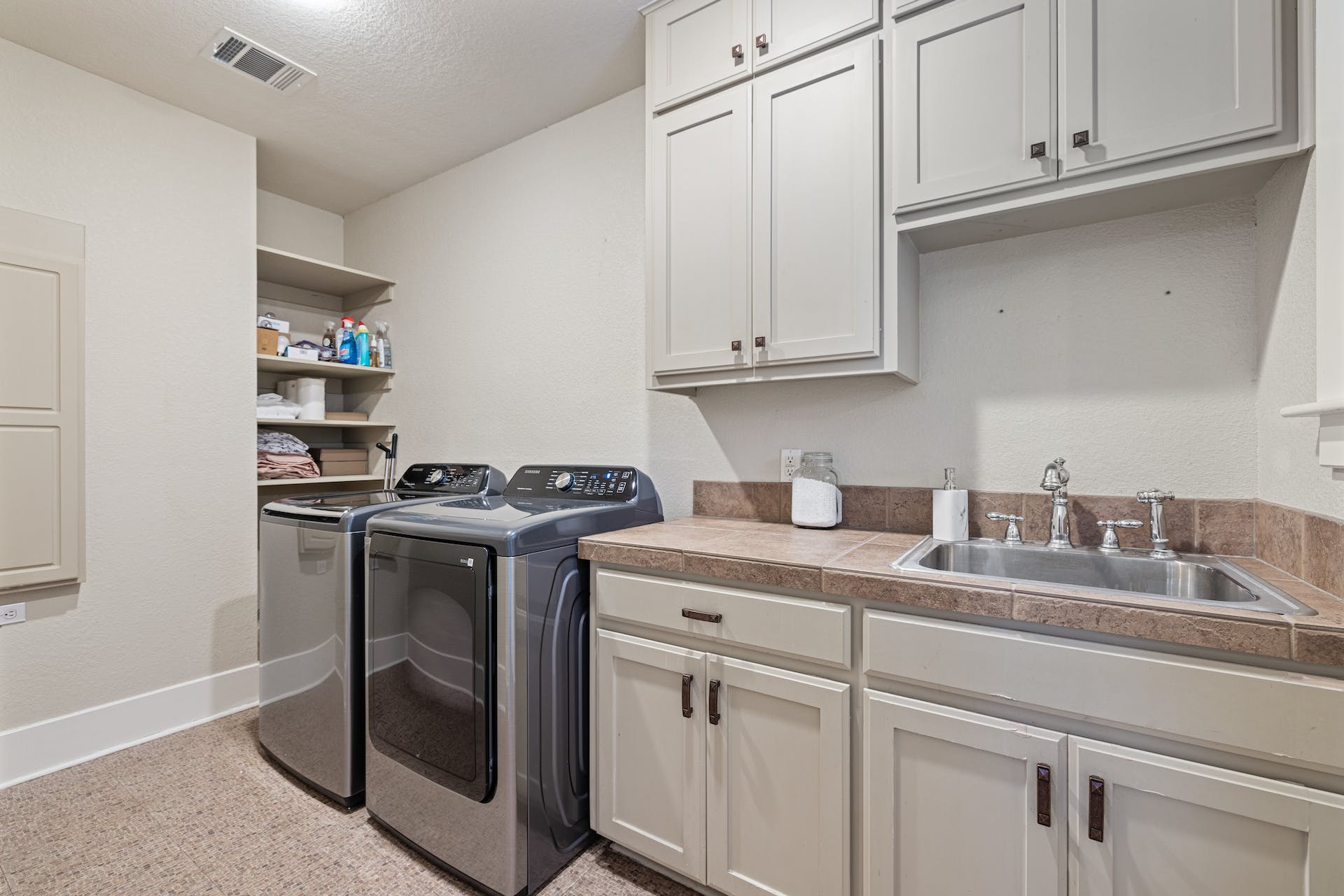 1211 Lexington Street Taylor, TX 76574 - Photo 24 of 40 a kitchen with stainless steel appliances granite countertop a sink stove and cabinets