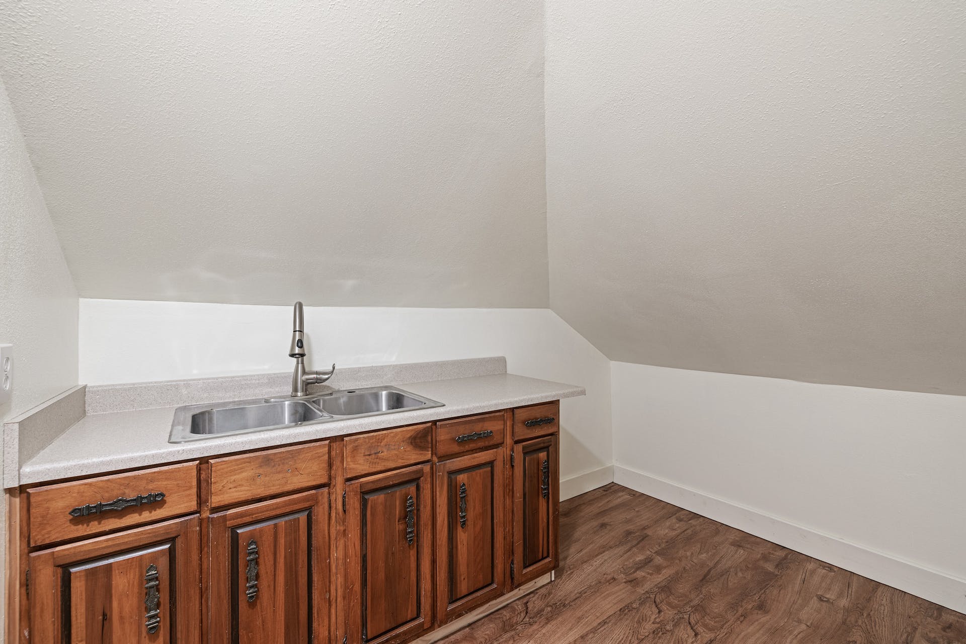 1211 Lexington Street Taylor, TX 76574 - Photo 32 of 40 a kitchen with a sink a cabinetry and wooden floor