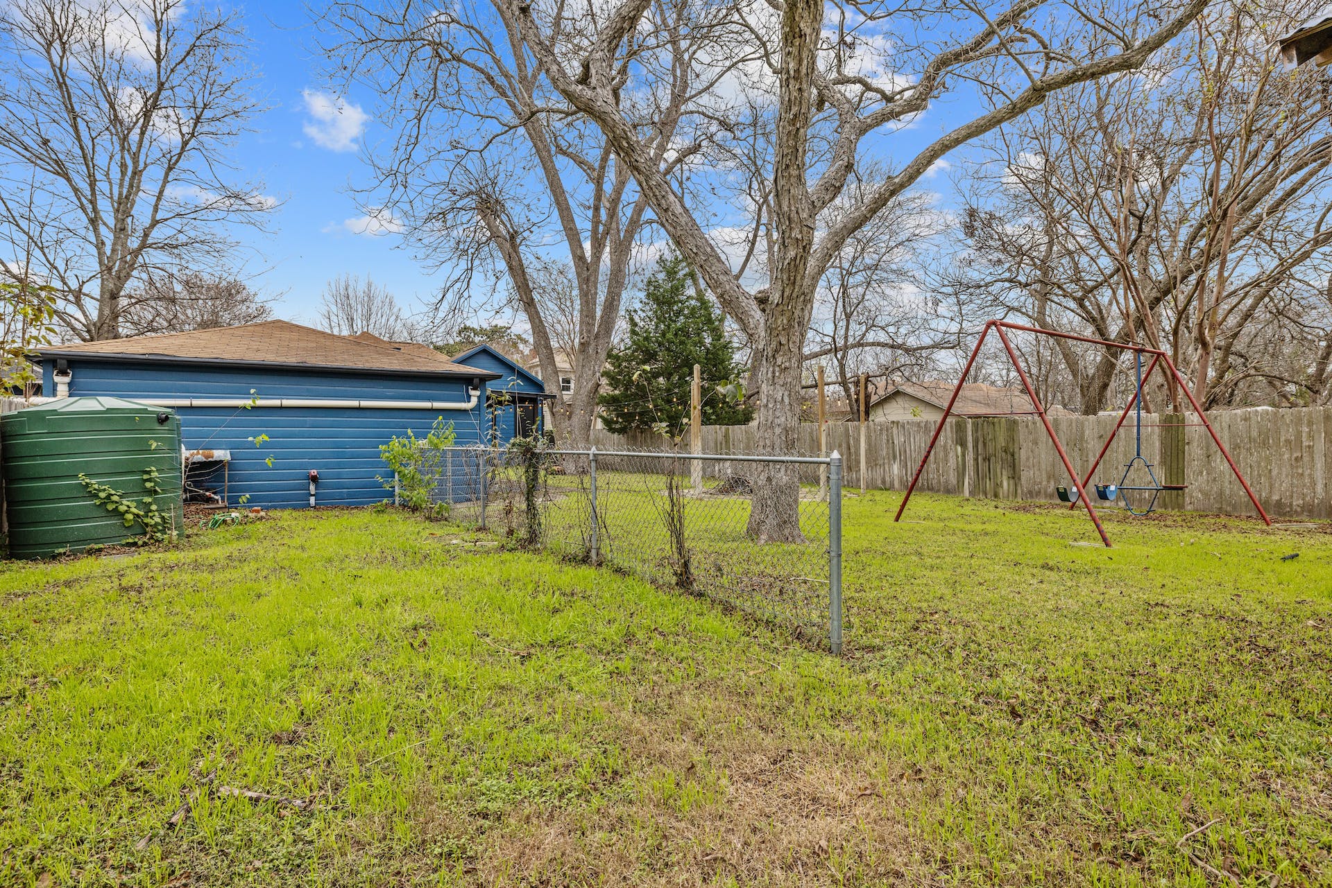 1211 Lexington Street Taylor, TX 76574 - Photo 36 of 40 a view of backyard with wooden fence and large trees