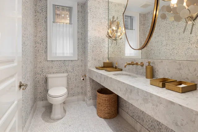 a bathroom with a sink a toilet and a mirror