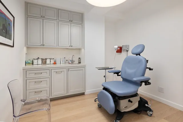 a room with a chair and white walls