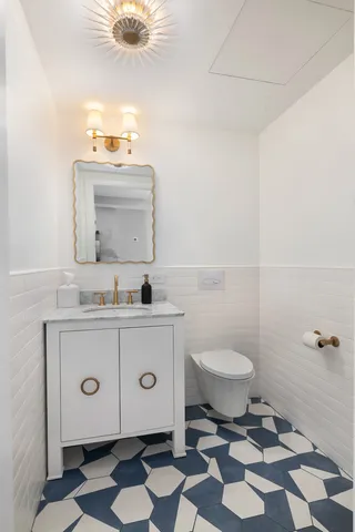a bathroom with a sink toilet and a mirror