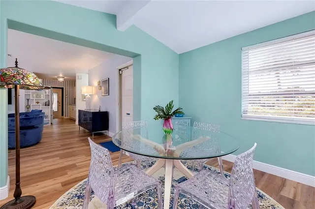 a dining room with furniture and wooden floor