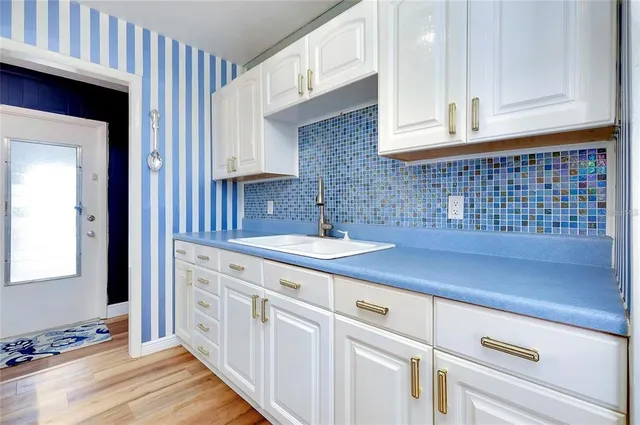 a kitchen with a sink cabinets and window