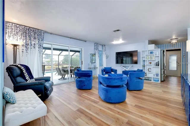 a living room with furniture large window and flat screen tv