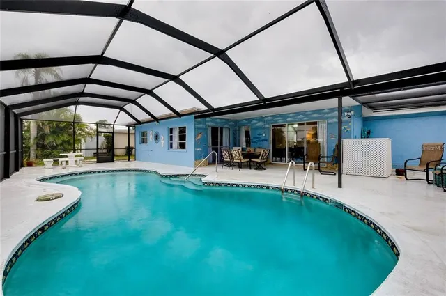 a swimming pool with outdoor seating and yard