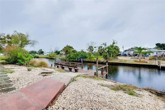 a view of a lake with boats and trees in the background
