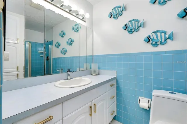 a bathroom with a sink a vanity and a mirror