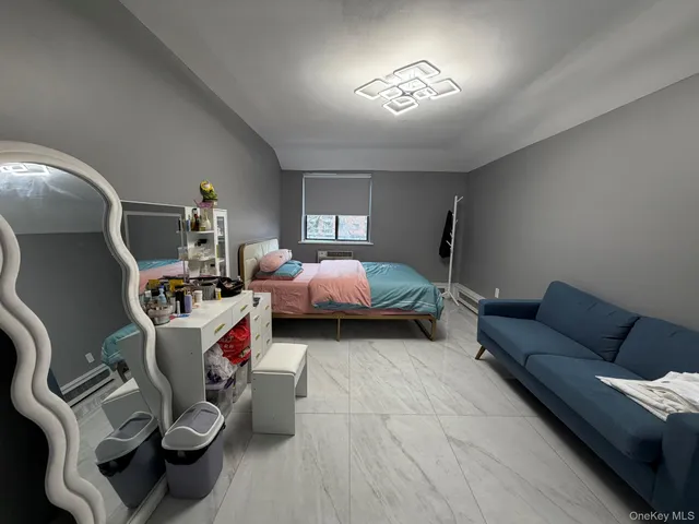 a bedroom with furniture and a wooden floor