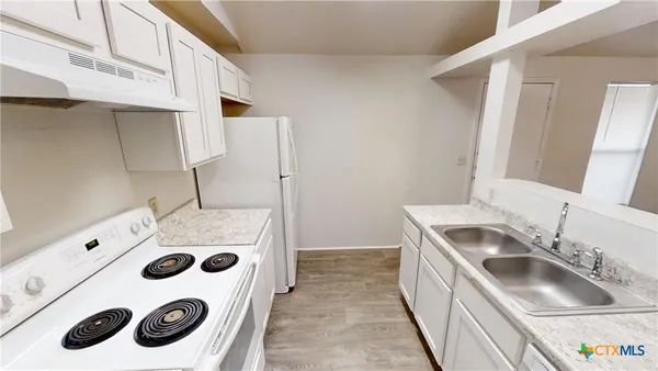 a bathroom with a sink and a washer dryer