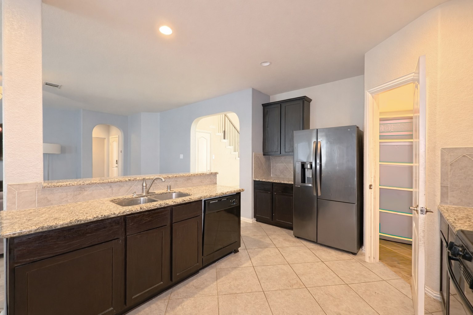 9707 Shimmering Lakes Drive Rosharon, TX 77583 - Photo 11 of 19 a kitchen with stainless steel appliances granite countertop a refrigerator and a sink
