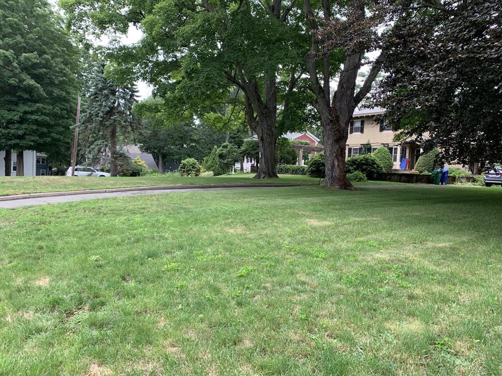 75 Pleasant Street Newton, MA 02459 - Photo 2 of 14 a backyard of a house with lots of green space and fountain
