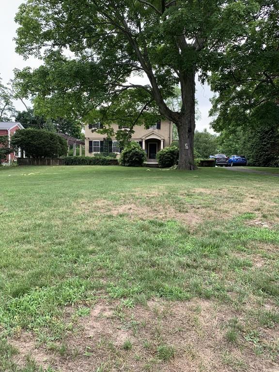75 Pleasant Street Newton, MA 02459 - Photo 6 of 14 a front view of a house with a garden