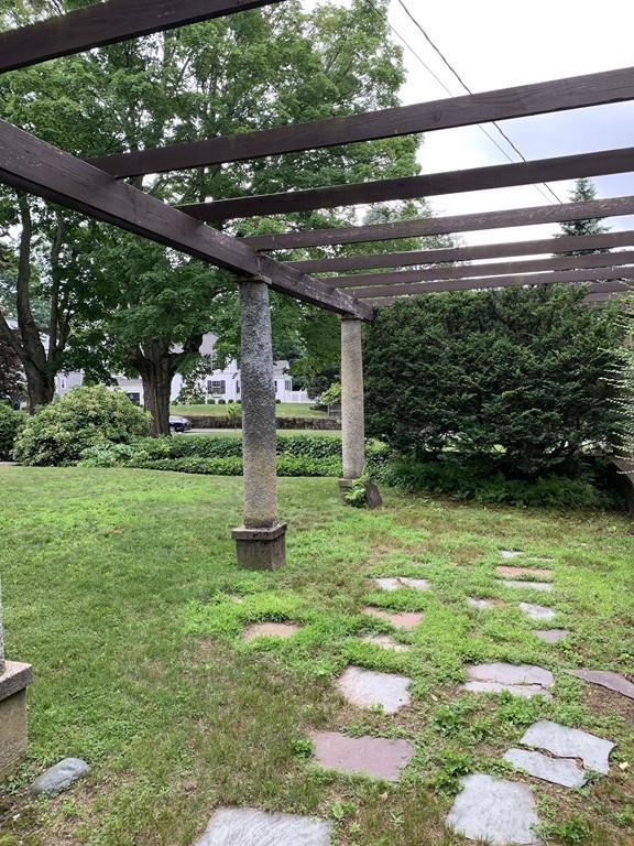 75 Pleasant Street Newton, MA 02459 - Photo 9 of 14 a backyard of a house with lots of green space and fountain
