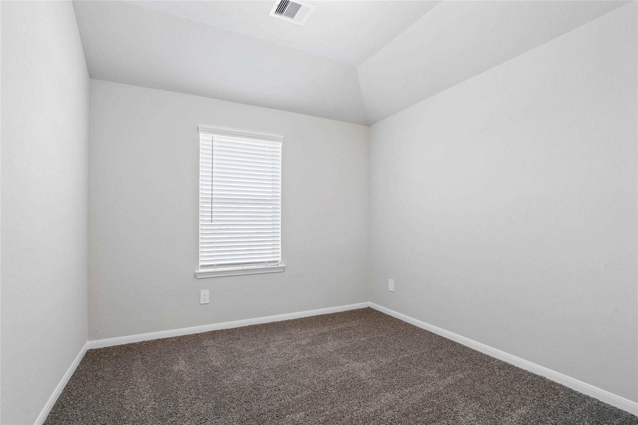 19657 Montgomery Rdg Way Montgomery, TX 77316 - Photo 36 of 49 This cozy secondary bedroom offers plush soft carpeting, neutral walls ready for personalization, a sun-filled window with fitted blinds, sloped ceilings, and a spacious closet for all your storage needs.