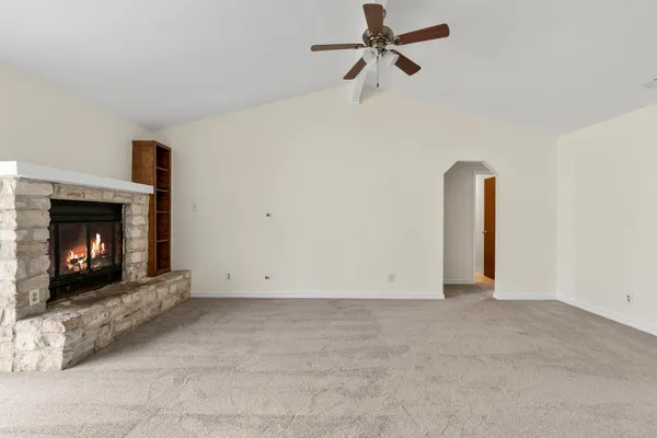 a view of an empty room with fire place and a fireplace