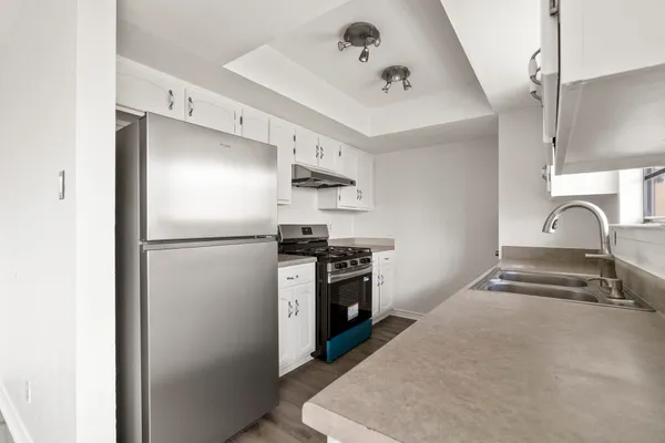 a kitchen with refrigerator and stove