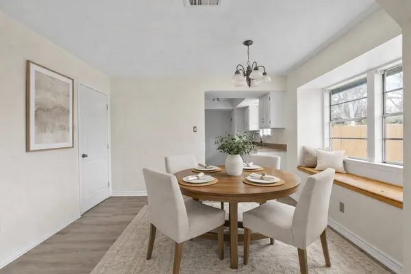 a view of a dining room with furniture window and wooden floor