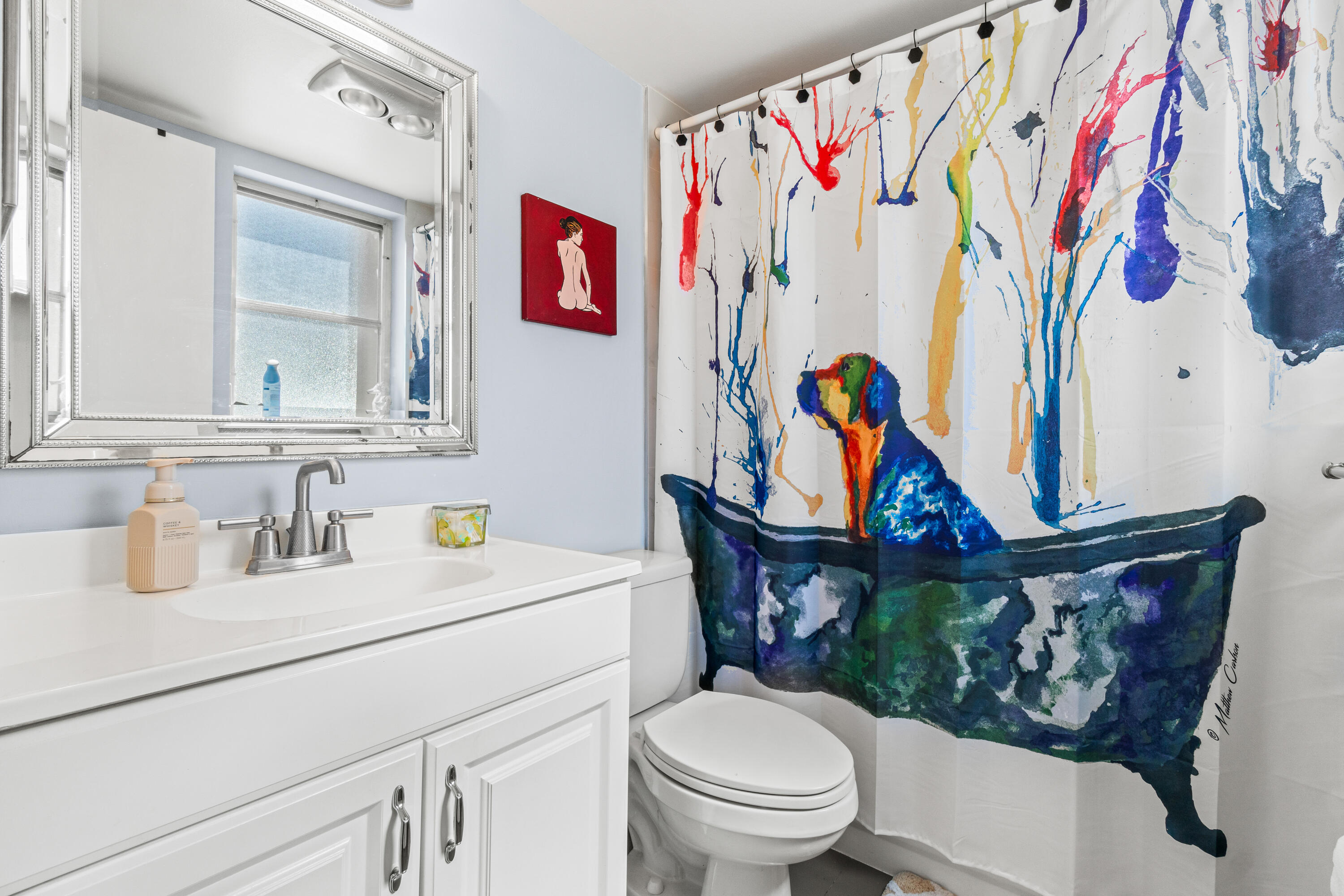 290 West Palmetto Park Road, Unit 114 Boca Raton, FL 33432 - Photo 17 of 25 a bathroom with a toilet sink and mirror