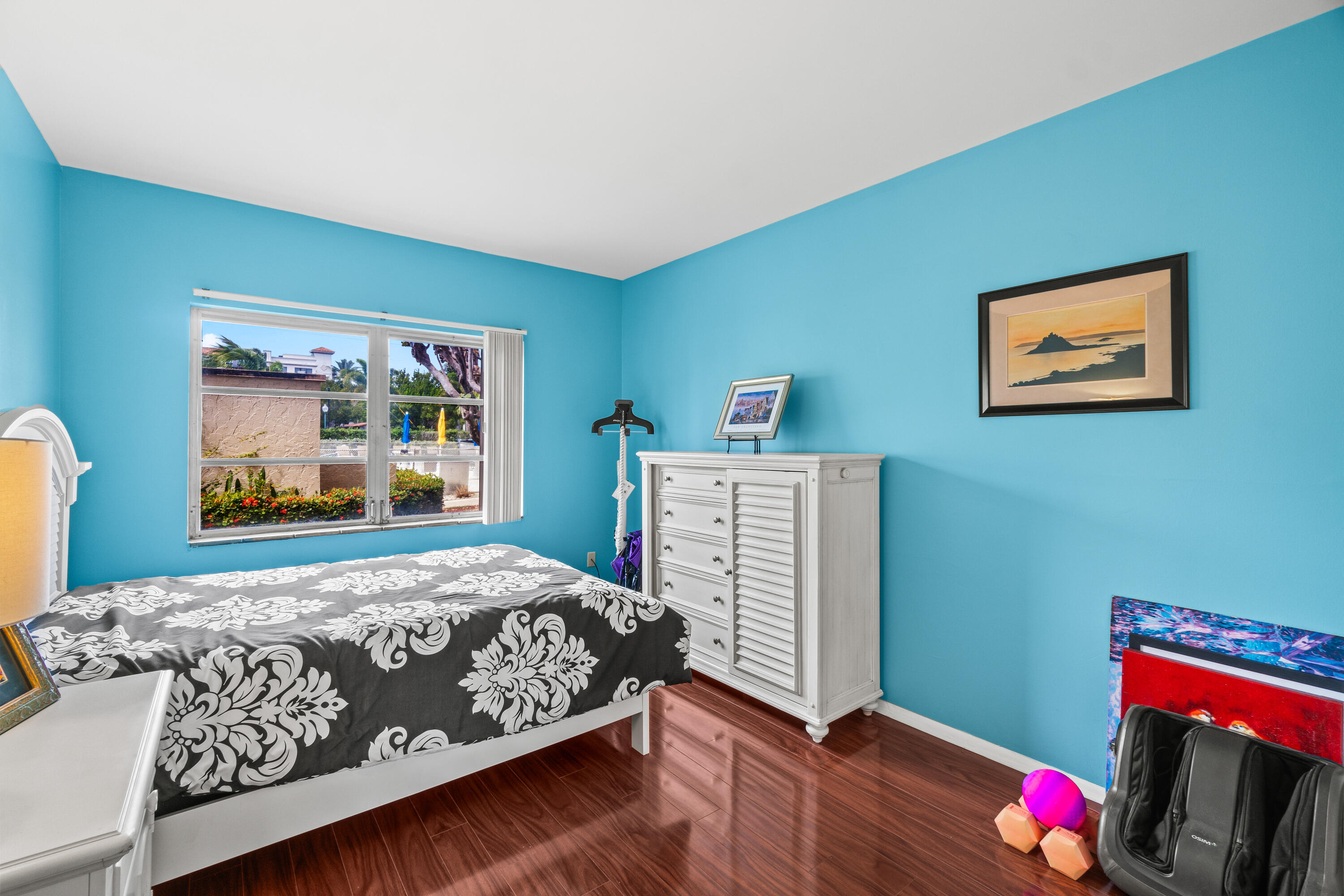 290 West Palmetto Park Road, Unit 114 Boca Raton, FL 33432 - Photo 18 of 25 a bedroom with a bed and wooden floor