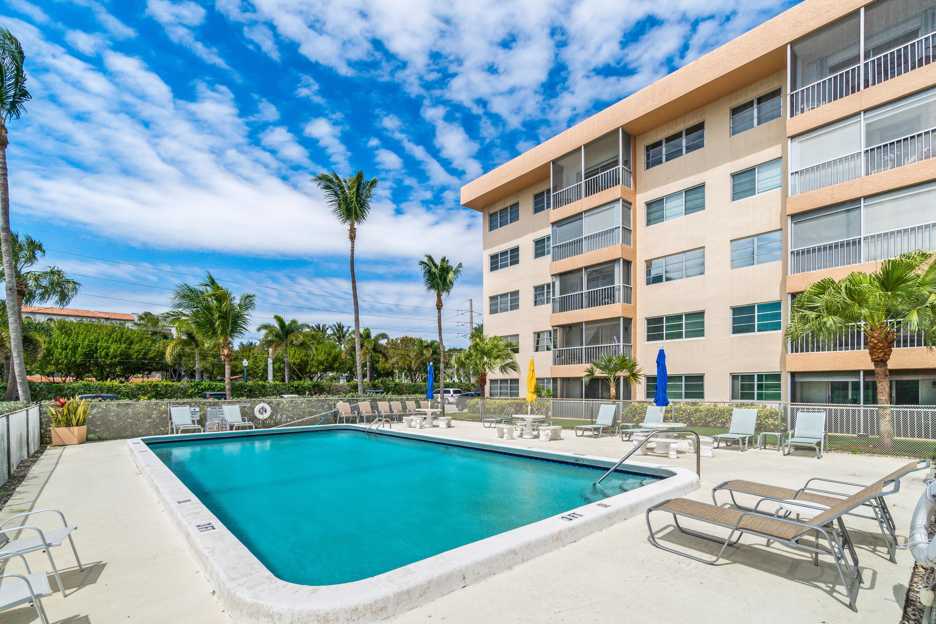 290 West Palmetto Park Road, Unit 114 Boca Raton, FL 33432 - Photo 20 of 25 a view of a swimming pool with a lounge chairs