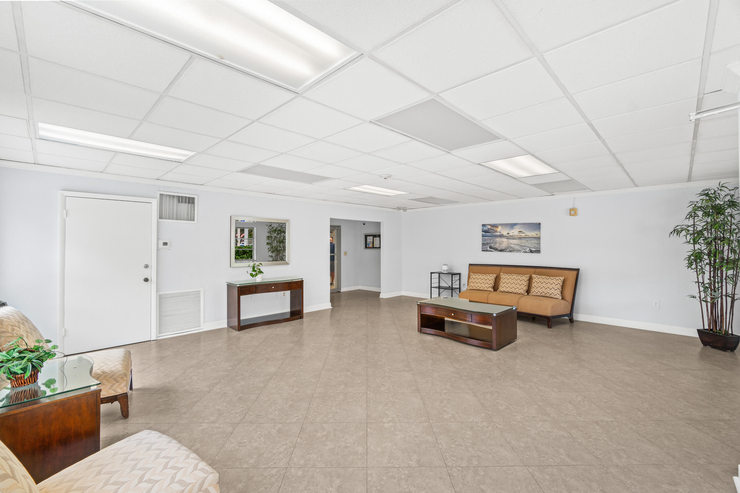 290 West Palmetto Park Road, Unit 114 Boca Raton, FL 33432 - Photo 23 of 25 a living room with furniture and flowers