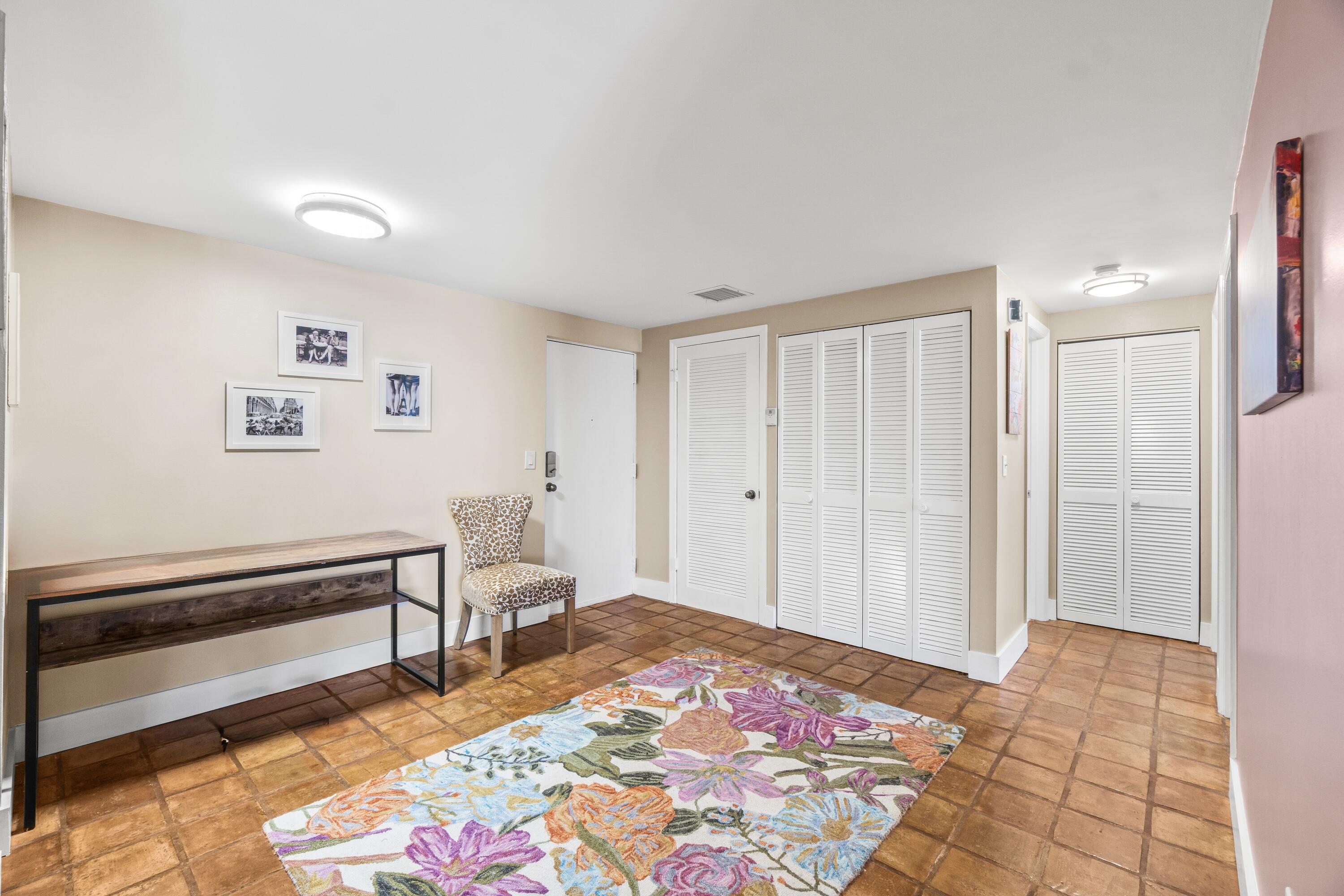 290 West Palmetto Park Road, Unit 114 Boca Raton, FL 33432 - Photo 3 of 25 a bedroom with a bed and a chandelier