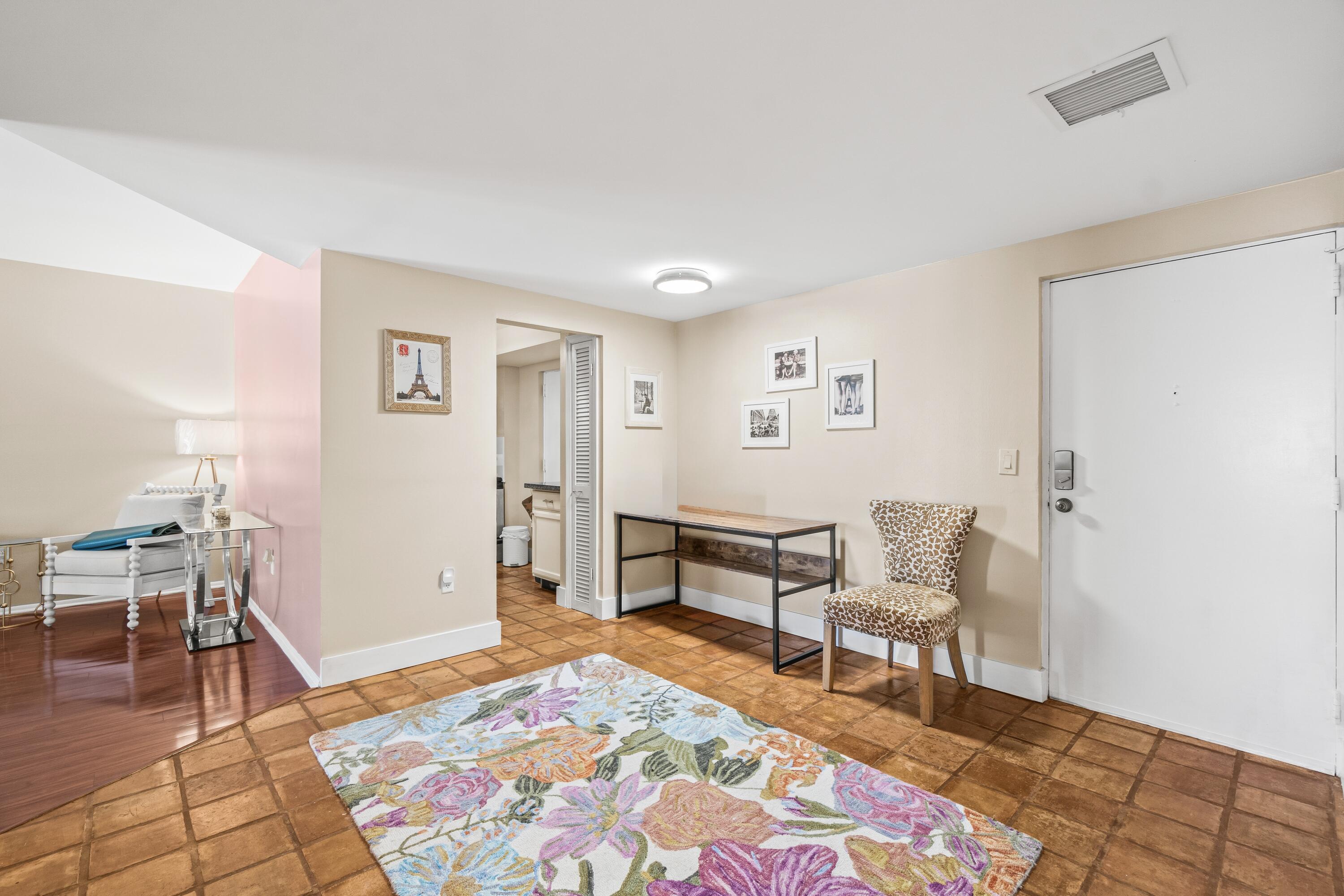 290 West Palmetto Park Road, Unit 114 Boca Raton, FL 33432 - Photo 5 of 25 a living room with furniture and a rug